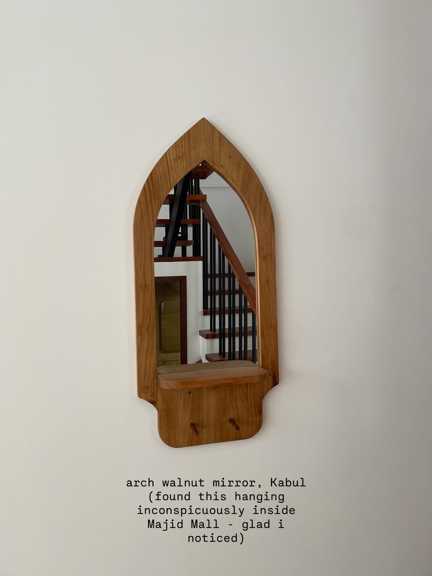 Arched wooden wall shelf with mirror detail